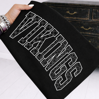 Woman's hand holding black crewneck sweatshirt with blacked out vikings tonal checkered and leopard stacked letter design
