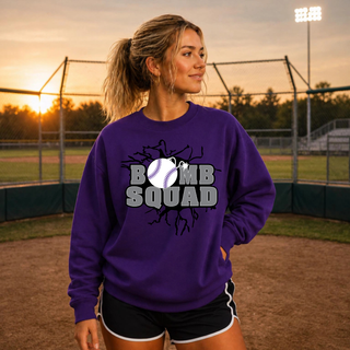Bomb Squad Dark Grey Softball Logo design on a purple crewneck sweatshirt