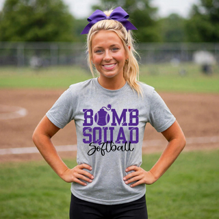 Woman wearing grey Bomb Squad Distressed Softball Logo top at a softball field