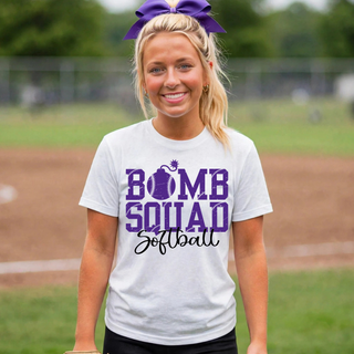 Woman wearing white Bomb Squad Distressed Softball Logo top at a softball field