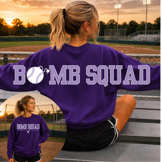 Woman wearing Bomb Squad Softball oversized back print purple crewneck at a softball field