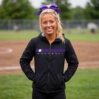 Woman wearing a black Bomb Squad Velocity Softball waterproof insulated jacket