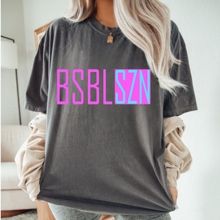 Woman wearing Comfort Colors pepper short sleeve top with hot pink and blue BSBL SZN block letter graphic