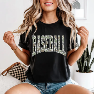 Woman wearing black Comfort Colors tee with arched camo Baseball varsity graphic
