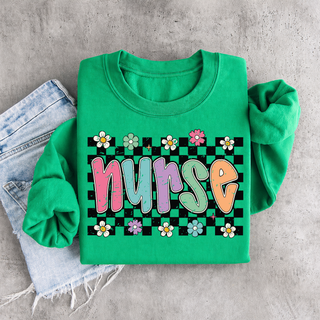 Kelly green crewneck folded flat with colorful nurse bubble letters on checkered daisy floral background design
