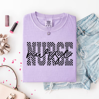 Violet tee with Nurse in checkered block letters and nurse in script overlay styled with denim and accessories flat lay
