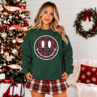 Christmas Plaid Smiley Face Graphic Top on forest green crewneck with red and green plaid smiley face design