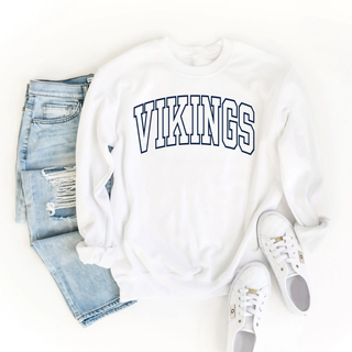 White crewneck with vikings varsity arch outline graphic, lifestyle flat lay with jeans and sneakers
