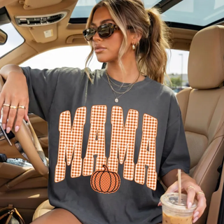 Woman wearing Comfort Colors pepper gray Mama gingham pumpkin tee with orange plaid lettering
