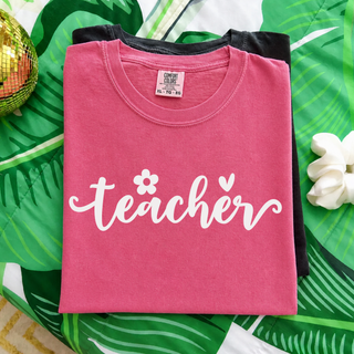 Crunchberry Comfort Colors adult tee folded flat with teacher daisy flower heart script design in white
