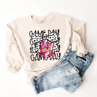 Sand Gildan crewneck with game day volleyball dalmatian bow graphic, flat lay with jeans

