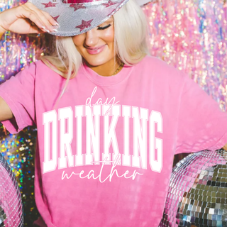 Woman in a blossom Comfort Colors tee with day drinking weather varsity graphic, disco ball background
