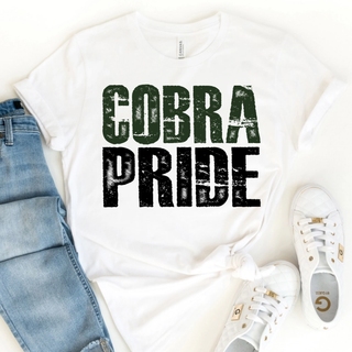 White tee with distressed dark green COBRA and black PRIDE stacked text, flat lay with jeans and white sneakers