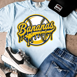Light blue short sleeve top with gold and navy dripping baseball graphic