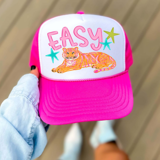 Easy Tiger Trucker Hat neon pink with colorful lounging tiger, Easy lettering, and teal and green star accents
