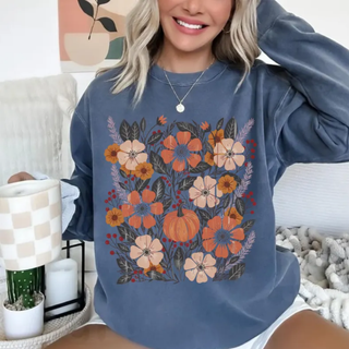 Woman wearing denim blue Comfort Colors graphic tee with fall floral bouquet and pumpkin design