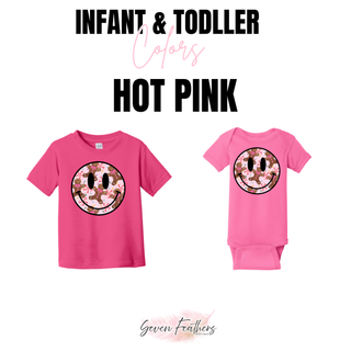 Hot pink infant and toddler tops featuring a faux-sequin-look Christmas smiley face with gingerbread, peppermint candies, bows, and sprinkles