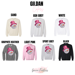 Gildan tee and crewneck color options featuring a snowman with a bright pink faux sequin-style hat.