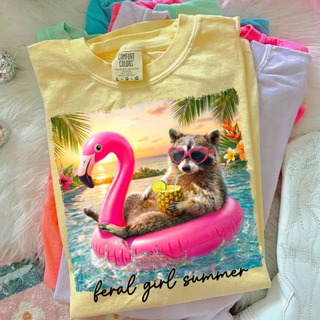 Butter Comfort Colors graphic tee with raccoon flamingo float tropical design folded flat lay