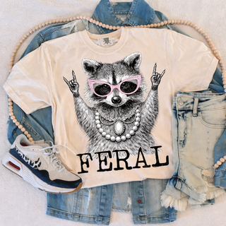 Ivory tee with Feral raccoon wearing pink sunglasses and pearl necklace graphic
