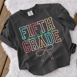 Pepper Comfort Colors fifth grade teacher bow graphic tee with retro varsity lettering flat lay
