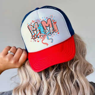 Woman wearing white rich red true royal trucker hat with firecracker doodle mimi patterned letters red white blue stars bows

