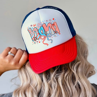 Woman wearing white rich red true royal trucker hat with firecracker doodle nana patterned letters red white blue stars bows
