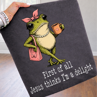 First of All Jesus Thinks I'm a Delight Sassy Frog Comfort Colors tee in pepper with frog holding coffee and pink purse graphic
