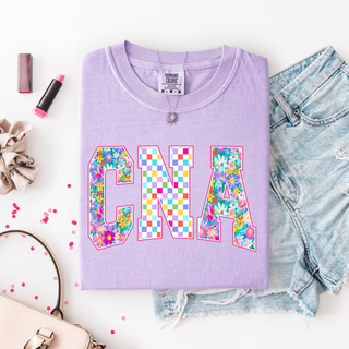 Floral Checkered CNA Graphic Top in violet with colorful floral C rainbow checkered N and floral A block letter design
