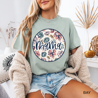 Woman wearing the Floral Mama Graphic Tee in bay with pink and sage floral circle and mama script design