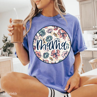 Woman holding iced coffee wearing the Floral Mama Graphic Tee in periwinkle with floral circle and mama script design