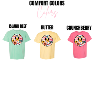 Floral smiley face top shown in Comfort Colors Island Reef, Butter, and Crunchberry