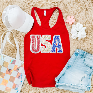 Red racerback tank flat lay with floral USA letters in red white and blue with lace border detail
