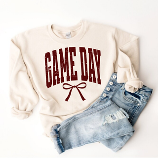 Ivory Game Day Maroon Bow top sweatshirt with distressed lettering styled with jeans