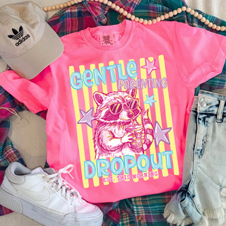 Neon pink tee laid flat with GENTLE PARENTING DROPOUT EST. THIS MORNING raccoon in sunglasses retro striped graphic
