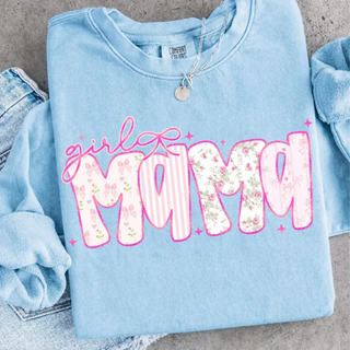 Light blue Comfort Colors sweatshirt folded with pink girl mama floral stripe and bow patterned letter design on concrete background