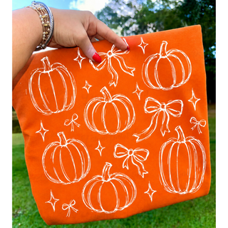 Orange girly bows and pumpkins top with hand drawn pumpkin and bow sketch design

