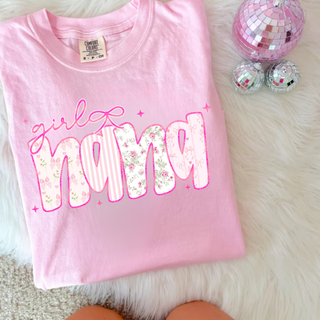 Blossom pink Comfort Colors tee with girly nana floral graphic featuring soft pink floral and stripe patterned letters with bow detail and sparkles