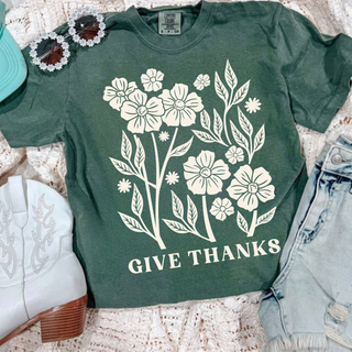 Comfort Colors moss tee with cream wildflower bouquet and Give Thanks lettering styled with white boots and denim
