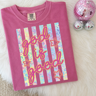 Folded Blossom Comfort Colors God Is Good Graphic Tee with pastel leopard stripes, pink script, gold outline stars on white fur with pink disco balls