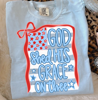Chambray Comfort Colors tee folded flat lay with God Shed His Grace On Thee patriotic bow flag graphic front view
