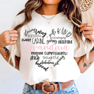 Ivory tee with grandma heart word cloud design featuring loving nurturing caring kind compassionate beloved on model
