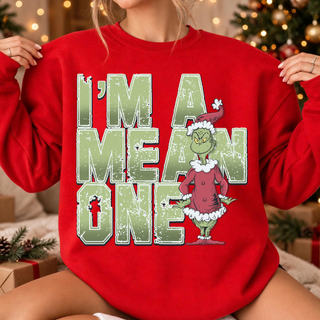 Green Man I'm a Mean One Top in red, on-model close-up of the distressed I'm a Mean One chest graphic with a Santa-suited green character