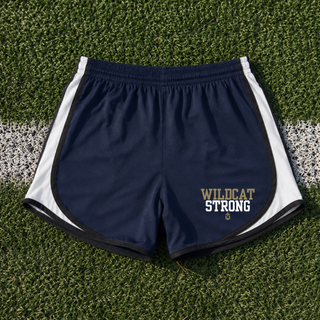 navy and white cadence performance short with wildcat strong lettering, flat lay on football field turf
