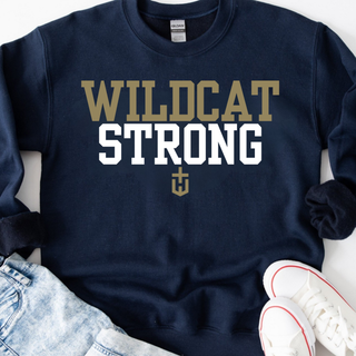 navy adult top with wildcat strong lettering and gold navy design, flat lay with white sneakers and denim
