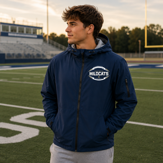 Man wearing navy Hayden Wildcats classic football laces waterproof insulated jacket on football field Topeka Kansas