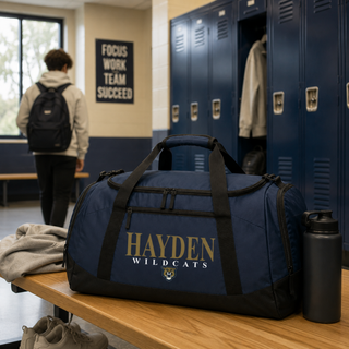 Navy Hayden Wildcats classic stack spirit duffle bag on bench in school locker room Topeka Kansas
