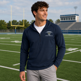 Man wearing navy Hayden Wildcats football laces repeat half zip hooded jacket on football field Topeka Kansas
