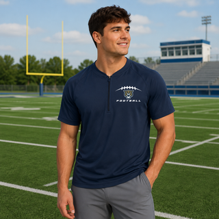 Man wearing Hayden Wildcats football laces repeat half zip short sleeve jacket in true navy on football field
