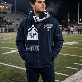 Man wearing navy Hayden Wildcats football laces waterproof insulated jacket on football field Topeka Kansas
